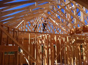 Roof trusses being put up on a job site that were provided by Lampasas Building Components